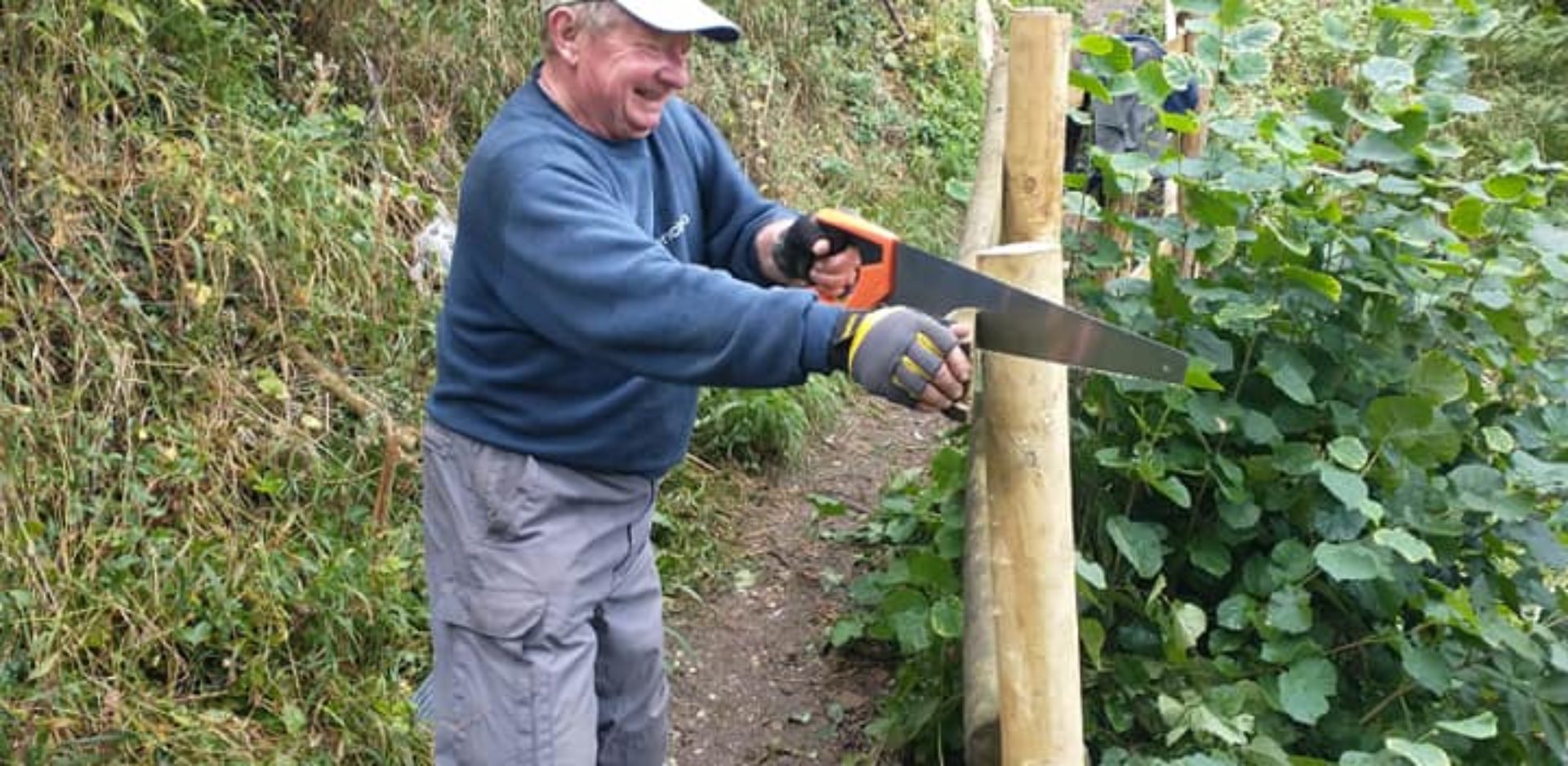 man working on improving a board walk