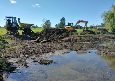 diggers behind mud and water