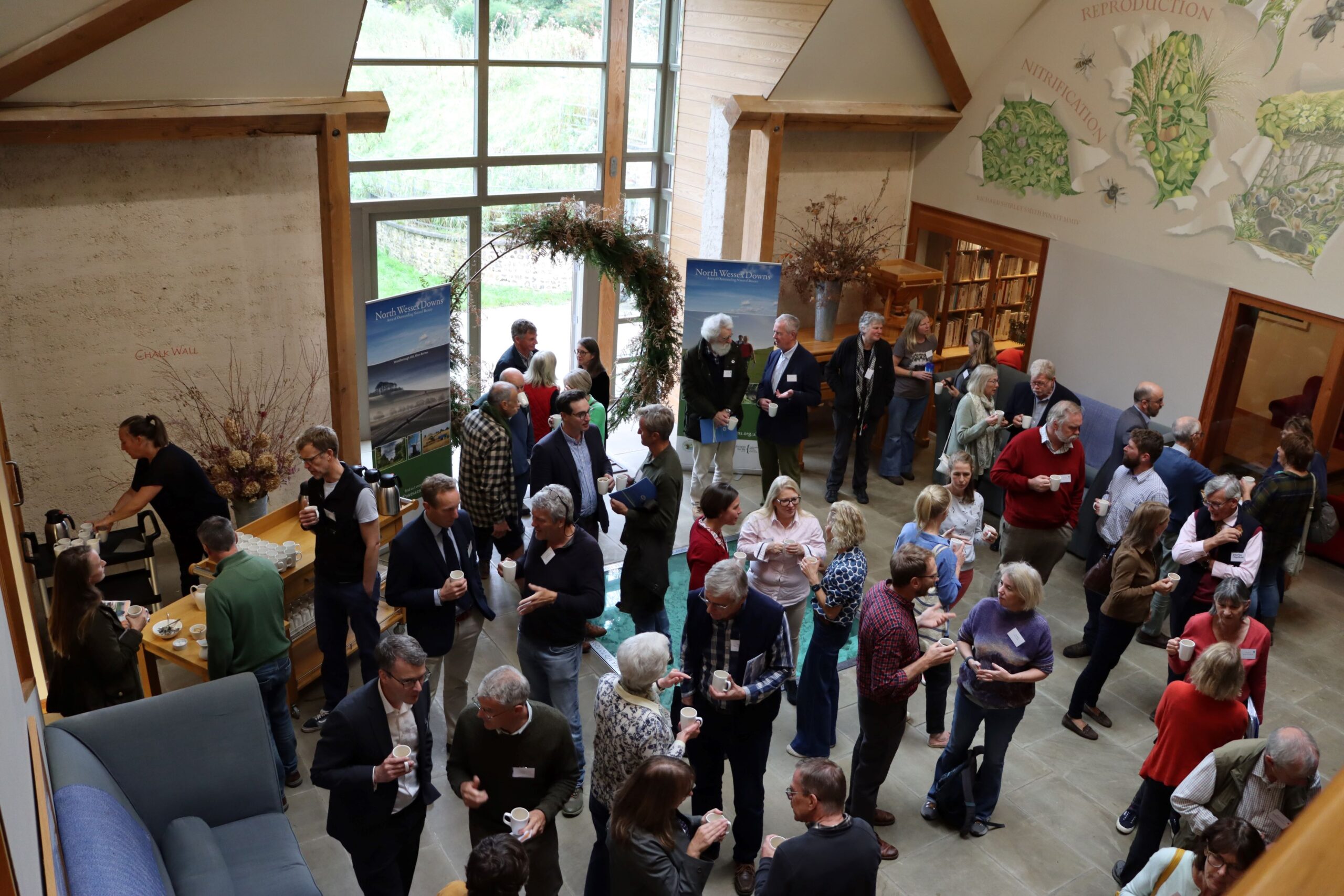 People stood chatting to each other in a large foyer